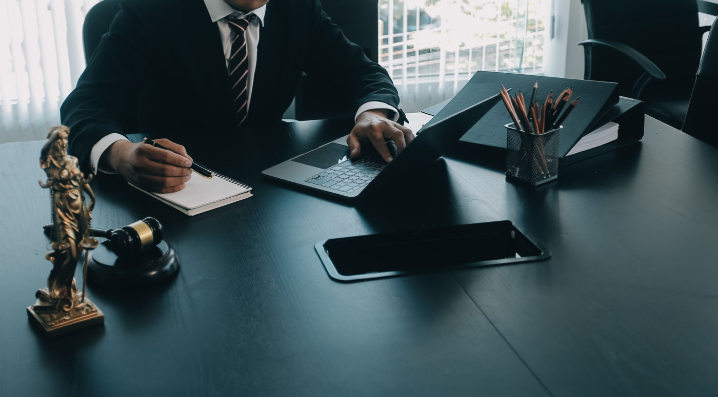 judge gavel with justice lawyers having team meeting at law firm