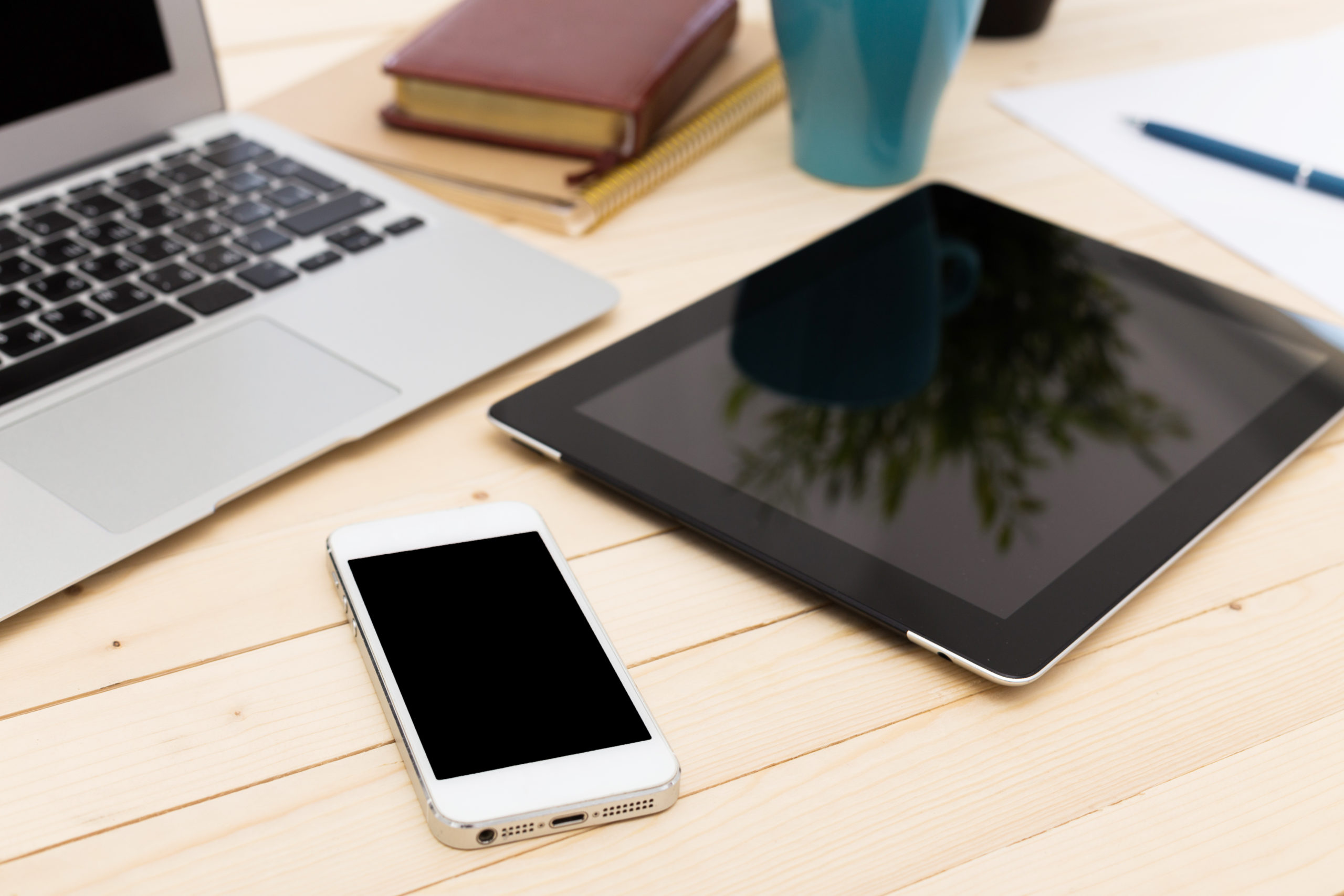 workspace with laptop, smartphone, and tablet showcasing a productive day ahead